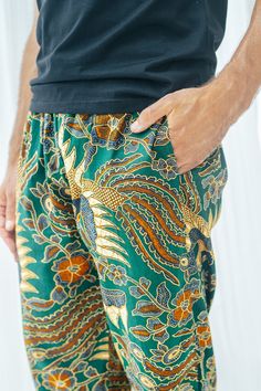 Men's Cotton Batik Drawstring Trousers *NEW* Now available in shorts!  Available in 5 different colours- Navy, Green, Royal Blue, Red and Red and Black Measurements- Small: Waist - 90cm (stretched out) , 55cm (not stretched) Length - 100cm Medium: Waist - 95cm (stretched out), 60cm (not stretched) Length - 103cm Large: Waist - 100cm (stretched out), 65cm (not stretched) Length - 105cm XL: Waist - 105cm (stretched out), 70cm (not stretched) Length - 107cm What you need to know: - Elasticated waistband - very stretchy, lots to give  - Drawstring tie - Pockets - Loose fit  - Made from Cotton  - Batik is made by hand using wax so there may be some imperfect ink dye marks - 5% of profits go to charityFor wholesale orders you can simply and easily buy from our Faire link- weartheworld.faire.comA Batik Pants, Hippy Pants For Men, Casual Batik Print Bottoms For Summer, Summer Cotton Bottoms With Batik Print, Hippie Men Pants, Bohemian Summer Batik Print Bottoms, Batik Men Outfit, Traditional Batik Print Summer Bottoms, Matted Hair