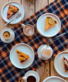 a table topped with plates and cups filled with food