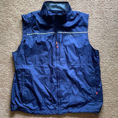 Great Condition Never Worn. Multiple Pockets. Vent In Back. Navy Sleeveless Outerwear With Pockets, Blue Sporty Sleeveless Outerwear, Sporty Sleeveless Blue Outerwear, Sleeveless Blue Outdoor Outerwear, Sleeveless Blue Outerwear For Outdoor Activities, Sleeveless Blue Outerwear For Outdoor, Blue Sporty Outdoor Vest, Blue Sporty Vest For Outdoor, Fishing Vest