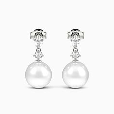 A stunning showcase of elegance and refinement, these drop earrings delight at first glimpse. Each earring features a lustrous pearl suspended with soft grace beneath a pear and round gemstone. The elegant design sways gently with your movements, gleaming subtly to draw admiring eyes. Whether worn for day or evening, the understated luxury of these drops enhances any outfit with impeccable taste and sophistication. *Each piece is handmade, resulting in a potential variance of 0.1-0.2mm during me Luxury Pear-shaped Pearl Drop Bridal Earrings, Elegant Pear Shaped Diamond Pearl Earrings, Elegant Pear-shaped White Gold Bridal Earrings, Elegant Pear-shaped Pearl Earrings, Elegant Pear-shaped Diamond Pearl Earrings, Elegant Pear-shaped Bridal Earrings For Formal Occasions, Classic Pear-shaped White Gold Bridal Earrings, Elegant White Gold Drop Pearl Earrings, Elegant White Gold Pear-shaped Pearl Earrings