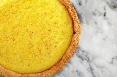 a yellow pie sitting on top of a marble counter