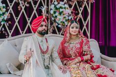 a bride and groom sitting on a couch