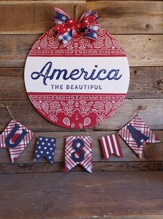 an american sign hanging on the side of a wooden wall next to bunting flags