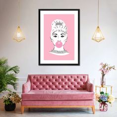 a pink couch sitting in front of a wall with a framed poster above it that says happy birthday