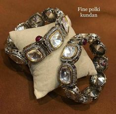 These Glam Victorian Polki Bangles Based in copper with rhodium plating. A perfect accessory for almost anything. This beautifully handcrafted bangle is set in silver and copper alloy and plated with 22k gold. It will go with everything and make your outfit super chic. Perfect to wear to dinner, and perfect gift for family members, friends or bridesmaid. LENGTH Bangle Size - 2.4 Closure - Screw. ...DETAILS -100% top Quality Faux Glass Polki -22K gold and silver Plated silver Ceremonial Silver Kundan Bangle, Silver Kundan Bracelets For Celebration, Festive Silver Kundan Bracelets, Silver Bracelets With Tilla For Celebration, Festive Fusion Silver Bracelets, Silver Kundan Bangle With Intricate Design, Traditional Silver Bangle With Stone Work, Silver Temple Jewelry Bangle For Celebrations, Handmade Silver Bangle For Celebration