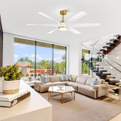 a living room filled with furniture and a staircase