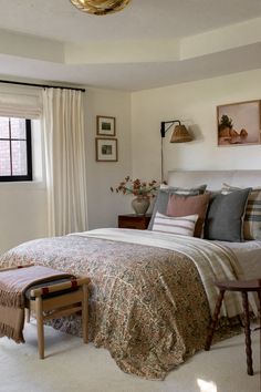 a bedroom with a large bed and white walls