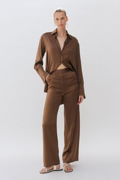 A trouser made of 100% silk. The wide leg floaty trousers features a fly opening, tailored waist band & side entry pockets and pressed centre fronts. Silk Trousers, Brown Silk, French Seam, Bamboo Silk, Poplin Shirt, Mother Of Pearl Buttons, Pearl Buttons, Tailored Trousers, Navy Stripes