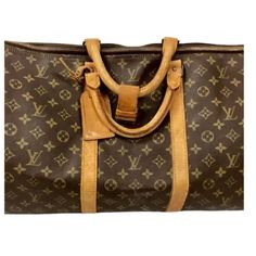 Timeless early 20th century Louis Vuitton Keepall travel Bag in classic monogrammed leather. Gold brass hardware, padlock and leather trim/tag all have the unique Louis Vuitton monogram. No key available.  Has double leather handles, 4.75" drop. Lightweight overnight or weekender bag. Rectangular Monogram Canvas Bag With Lock, Monogram Canvas Tote Travel Bag, Elegant Monogram Canvas Travel Bag With Leather Trim, Luxury Bag In Monogram Canvas With Brass Hardware, Travel Bag With Brass Hardware And Monogram Canvas, Classic Bags In Monogram Canvas With Lock, Classic Bag With Lock In Monogram Canvas, Classic Bags With Lock In Monogram Canvas, Classic Monogram Canvas Bag With Lock