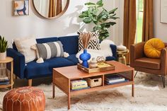 a living room filled with lots of furniture and decor on top of a white rug