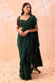 Emerald green satin crepe ruffle pre-draped saree with pleated detailing. Comes with a floral hand embroidered padded blouse. - Aza Fashions Elegant Draped Ruffle Blouse, Elegant Green Draped Blouse Piece, Fitted Chiffon Pre-draped Saree With Ruffles, Fitted Draped Blouse With Ruffles, Fitted Green Pre-draped Saree With Ruffles, Green Ruffled Pre-draped Saree For Wedding, Green Ruffled Pre-draped Saree For Reception, Elegant Green Ruffled Pre-draped Saree, Green Chiffon Blouse Piece For Wedding