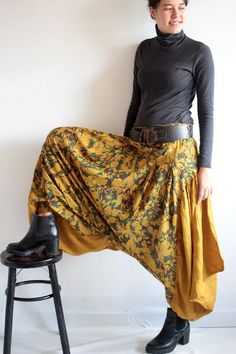 Keep on the funky side of life.Harem pants made from super full balloon shape skirt. We used at least 5 meters of fabric on this item.Elastic waist. Gathered in pleats around the whole waist. Patched on the sides with big ruffle piece in triangle shape. Then gathered on the bottom part in shirring smock to make the leg hole.2 kinds of fabric. Floral print in the middle and solid color fabric on the side (in dark color, the print is subtle)  Beautiful and flattering to woman in all shape. Lots of Baggy Harem Bottoms For Fall, Bohemian Fall Festival Bottoms, Bohemian Harem Pants For Fall Festival, Relaxed Fit Harem Bottoms For Fall, Loosely Fitted Harem Bottoms For Fall, Bohemian Flowy Green Bottoms, Green Flowy Bohemian Bottoms, Flowy Green Bohemian Bottoms, Bohemian Harem Trousers For Fall