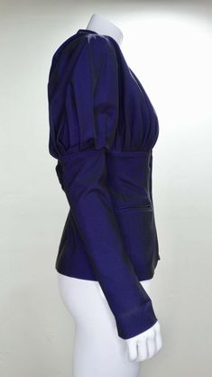 For Sale on 1stDibs - Circa late 1980s, this stunning Romeo Gigli Victorian style blazer features a beautiful deep iridescent purple color and large leg-o-mutton sleeves. Pleating Fitted Blazer With Structured Shoulders For Party, Tailored Outerwear With Structured Shoulders For Parties, Evening Outerwear With Structured Shoulders, Evening Outerwear With Structured Shoulders For Fall, Winter Blazer With Structured Shoulders And Long Sleeves, Fall Office Outerwear With Puff Sleeves, Elegant Purple Blazer For Fall, Winter Purple Blazer For Party, Winter Evening Outerwear With Structured Shoulders