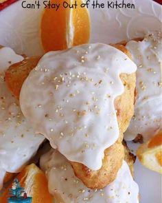 oranges and donuts with icing on a white plate