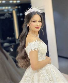 a woman wearing a tiara standing in front of a mirror