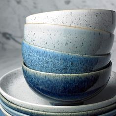 a stack of blue and white bowls sitting on top of each other