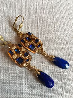 Vintage Blue Nuggets on Golden Support and Lapis Lazuli Tear Drop Earrings. Small Blue Glass Nuggets.  Gold Plated Frame. Vintage Brass Lever back Closure.  Size :  3 inches                (7.5 cm) Blue Brass Dangle Jewelry, Blue Teardrop Brass Jewelry, Blue Brass Dangle Earrings, Bohemian Lapis Lazuli Teardrop Jewelry, Blue Metal Clip-on Jewelry, Gold Teardrop Lapis Lazuli Earrings, Vintage Lapis Lazuli Jewelry For Gifts, Blue Lapis Lazuli Drop Earrings, Luxury Vintage Lapis Lazuli Jewelry