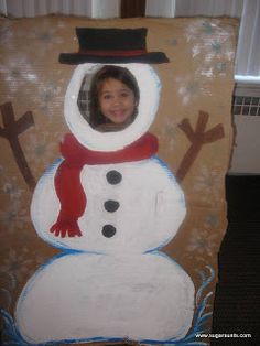 a cardboard snowman with a hat and scarf