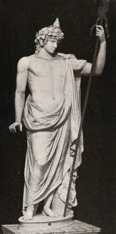 an old photo of a statue holding a staff