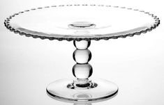 an empty glass cake plate on a white background