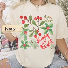 Cute preppy Christmas shirt. Retro Christmas holly berries design. This merry and bright  merry Christmas has a watercolor look--giving it a vintage vibe. Trendy oversized aesthetic. Cute vintage inspired Christmas design. Makes a great holiday gift for friends, daughters, moms, sisters, co workers etc.  (If you don't like the vintage, aged look & oversized fit--let us know! We can print this design for you on a bella canvas tee (crisp colors, slimmer fit)    Comfort colors uses a superior dye p Vintage Christmas Design, Cottage Core Christmas Shirt, Trendy Christmas T-shirt Crew Neck, Vintage Christmas Graphic Print Tops, Trendy Christmas Crew Neck T-shirt, Retro Christmas Tshirt, Cottage Core Christmas, Cottagecore Christmas, Oversized Aesthetic