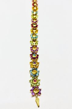 This is a beautiful multi-color flowers bracelet with different types of stones. Precious Metal: 14 Karat Yellow Gold. Gemstone: Garnet,Amethys,Pink Amethys,Topas,Aquamarine,Peridot Stones. Available Size: Length: 7.5 inches. Width: 9.9 mm. Available Weight: ~13.1 grams* May be available in other sizes. Please inquire. *All weights are approximate. **Pendant sold separately. Please contact us if you have further questions about alternate sizes or styles, availability, specifications, and persona Multi Colored Flowers, Peridot Stone, Color Flower, Popular Jewelry, Jewelry Diamond, Gem Stones, Flower Jewelry, Types Of Stones, Flower Bracelet