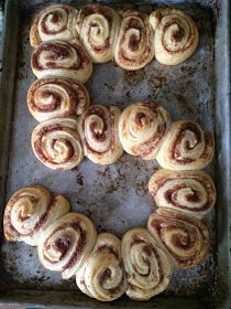 a pan filled with cinnamon rolls on top of a baking sheet