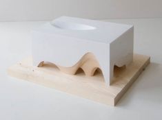 a small white object sitting on top of a wooden stand