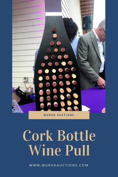 the cork bottle wine pull is sitting on top of a table with people looking at it