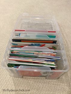 a plastic container filled with files and folders on top of a carpeted floor