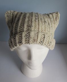 a white mannequin head wearing a knitted hat