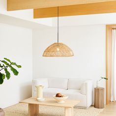 a living room filled with furniture and a large light fixture hanging over the top of it