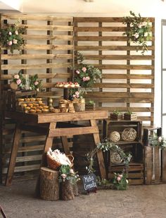 a wooden table topped with lots of cakes and cupcakes on top of it