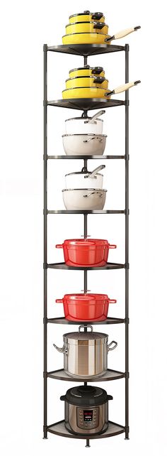 a stack of pots and pans on top of a metal rack next to an oven