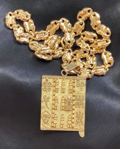 This handmade necklace is a stunning, unique piece of jewelry!  Weighing 50.1 grams (chain and pendant), the large size and beautiful shine of 18 karat yellow gold is an eye-catching conversation piece.  The peanut-style chain is 26 inches and the pendant is 1.75 in wide by 2.5 inches tall. Designed as a good luck/wealth charm in the style of an ancient African Dogon door, the pendant features a carved lock, warriors, animals, and spiritual symbols.  This necklace looks absolutely regal and would be a wonderful addition to your jewelry collection. Yellow Gold Pendant Chain Necklace, Luxury Gold Rectangular Necklace, Gold Medallion Necklace For Good Luck, Traditional Yellow Gold Good Luck Necklace, Custom Gold Plated Pendant Necklace, Custom Gold-plated Pendant Necklace, Gold Amulet Necklace For Good Luck, Yellow Gold Chain Necklace With Square Pendant, Gold Engraved Pendant Chain Necklace