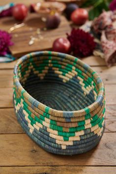 a woven basket sitting on top of a wooden table