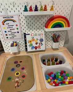 the table is set up with toys and books for children to learn colors in their homes