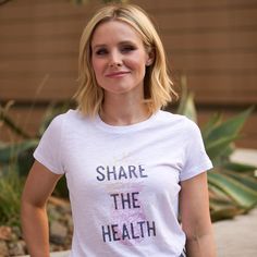 a woman wearing a white shirt that says share the health