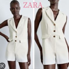 Sleeveless Short Blazer Jumpsuit With V-Neck Lapel Collar. False Front Flap Details. Front Zip And Golden Button Closure. Oyster White | 1971/155 Outer Shell 94% Polyester 6% Elastane White Fitted Jumpsuits And Rompers With Buttons, Fitted White Jumpsuits And Rompers With Buttons, Elegant Sleeveless Jumpsuits And Rompers With Buttons, Chic White Jumpsuits And Rompers With Buttons, White Spring Jumpsuits And Rompers With Buttons, White Buttoned Jumpsuit For Spring, Elegant White Jumpsuits And Rompers With Pockets, Zara Jumpsuit, Jumpsuit And Blazer