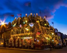 a building covered in christmas lights on the street