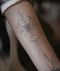 a woman's arm with a tattoo on it and an arrow in the middle