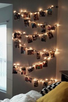 a bedroom decorated with lights and pictures on the wall