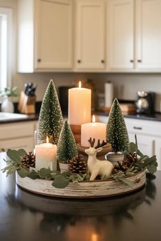 a candle holder with candles and christmas decorations on top of a table in a kitchen