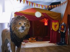 a lion statue standing in front of a circus tent