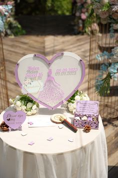 a table topped with a heart shaped sign