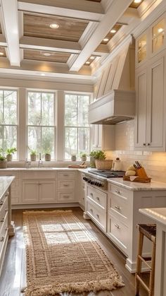 a large kitchen with white cabinets and wooden flooring on the ceiling, along with an area rug