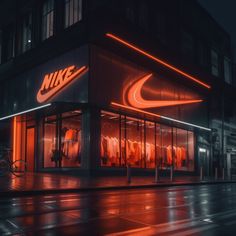 the nike store is lit up at night