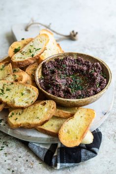 a plate with bread slices and a bowl of food on it