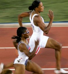 two women running on a race track