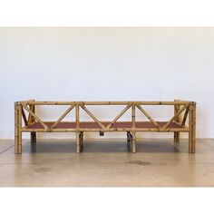 a wooden bench made out of bamboo sticks